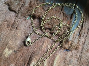 Antique sterling charm on vintaj chain